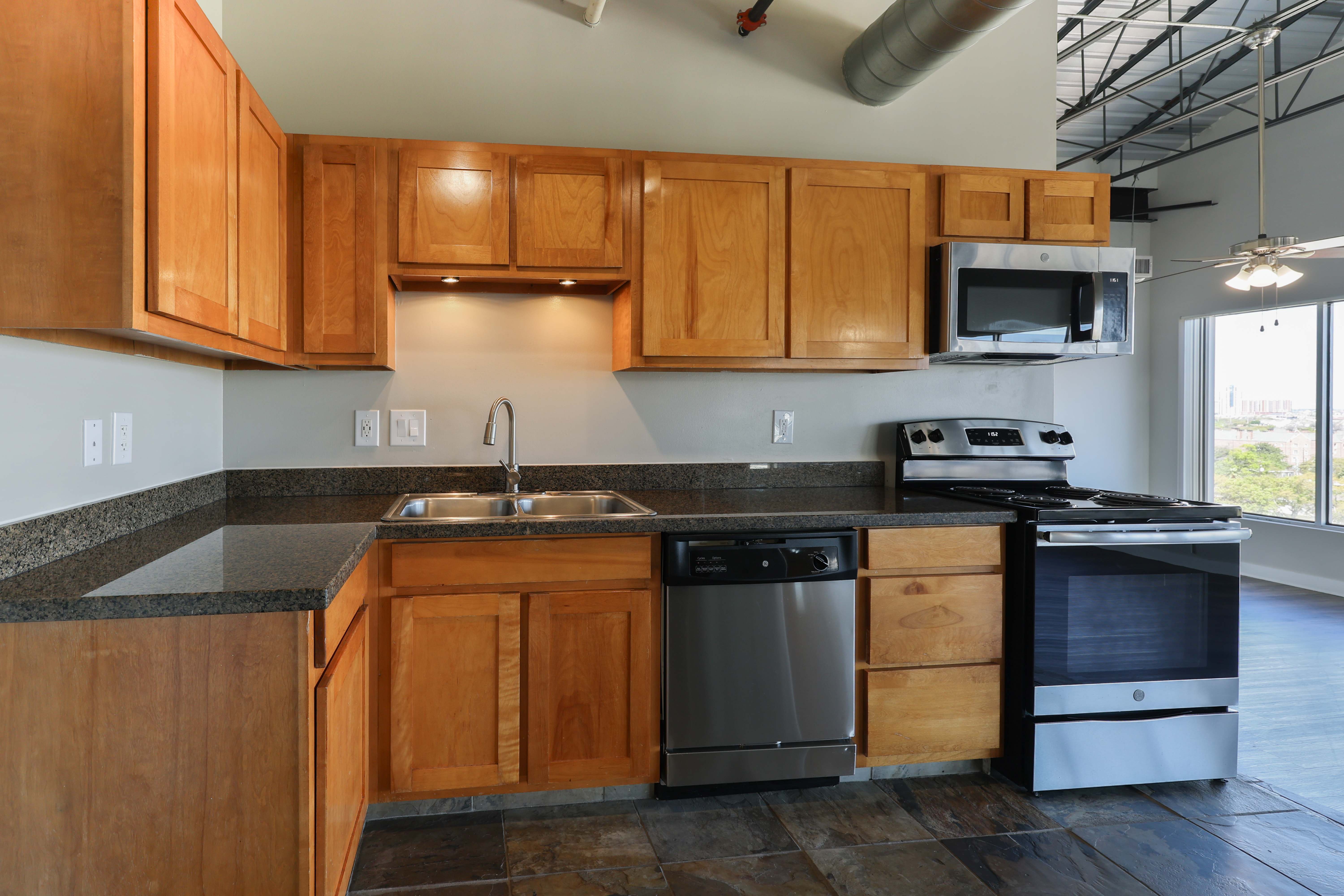 A kitchen with wooden cabinets and stainless steel appliances.