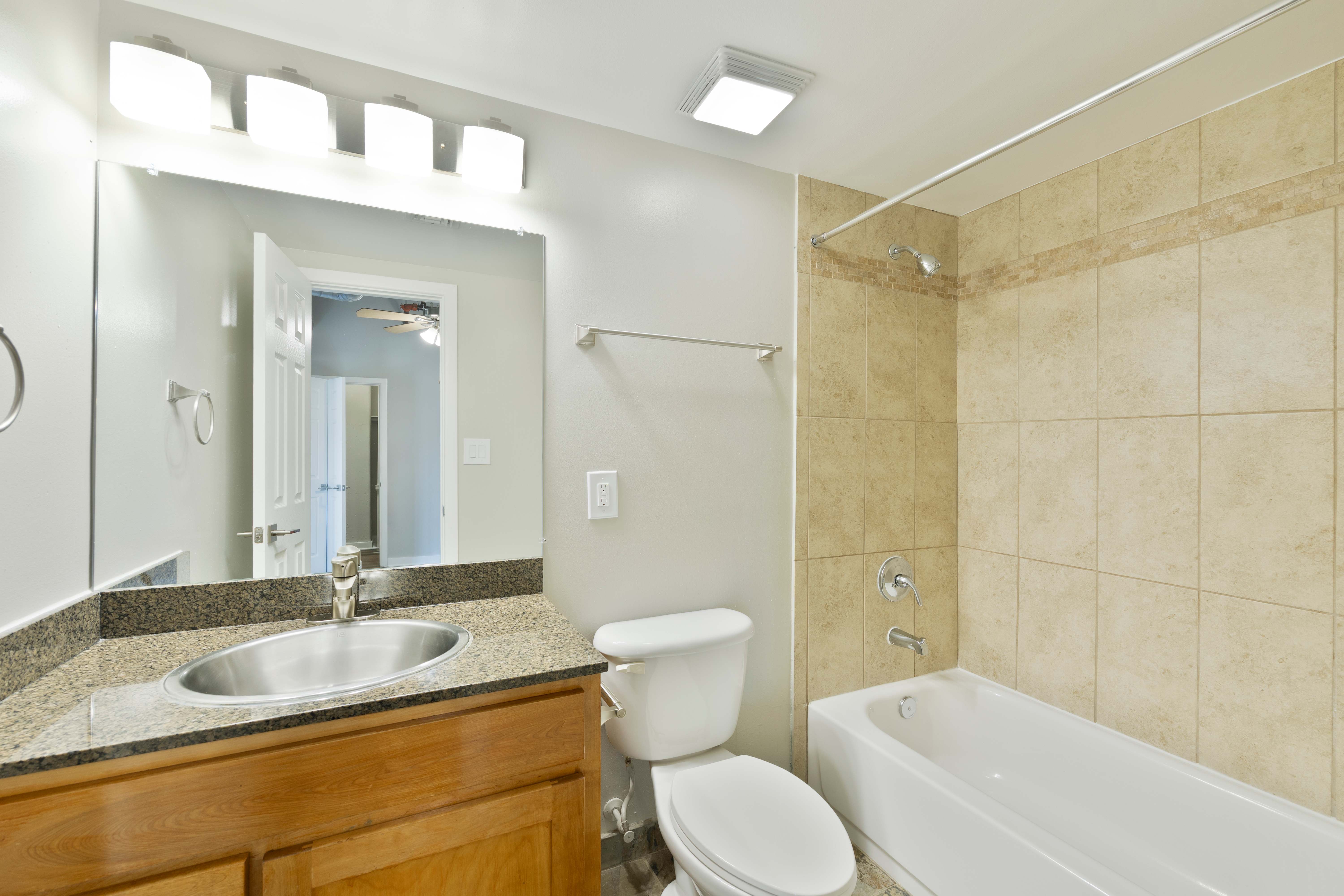 A bathroom with a sink, toilet, and bathtub.